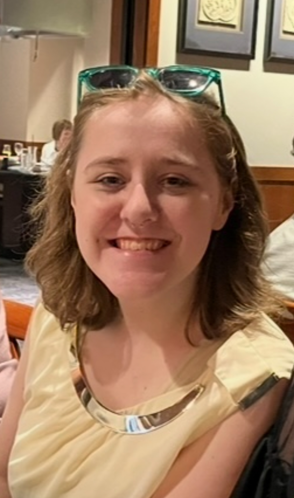 Maysen smiling with teal sunglasses and blonde hair